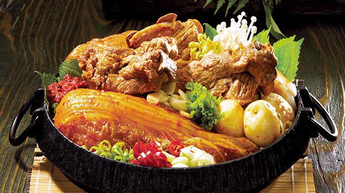 Gamjatang: Pork bone broth with pork backbone, pork meat, potatoes, and aged kimchi boiled in an iron pot.
